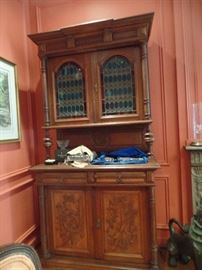 Antique cabinet with stain glass and hand carved doors