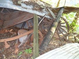 More old plows and wagon wheels
