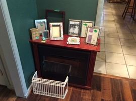 Lots of picture frames throughout house - these are sitting on the electric fireplace heater.