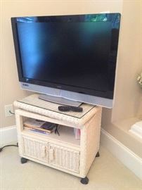 Flatscreen TV on swivel top wicker cabinet