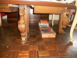 carved griffins coffee table (under a dining table)