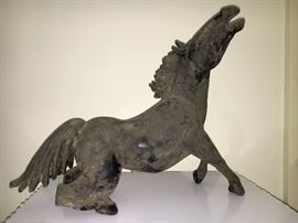 Hand made, one of a kind, giant black glass horse with textured surface shadowing.