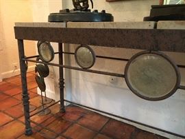 Great stone top console table with glass circle insets in front.