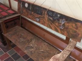 Heavy metal bench, with cactuses and other Arizona motifs.
