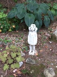 Scary cement girl and garden.