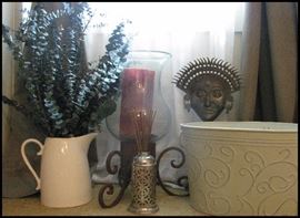 Decorator pieces including eucalyptus, large candles (there are two of these) brass sculpture and ornate tub