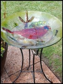 Glass birdbath on iron stand with cardinal design
