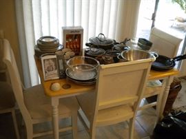 Table and 4 chairs and kitchen ware.