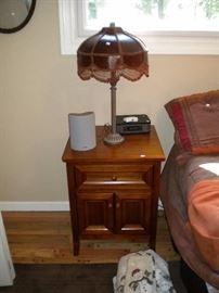 Night stand , lamp and radio.