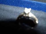14 karat white gold diamond ring, 1/4 carat center with 16 points in the 8 side stones. Center is a SI-2, I color, .46 carat total weight