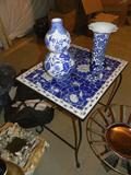 metal small table with mosaic top in predominantly blues and whites with just two of the many blue and white ceramic pieces available