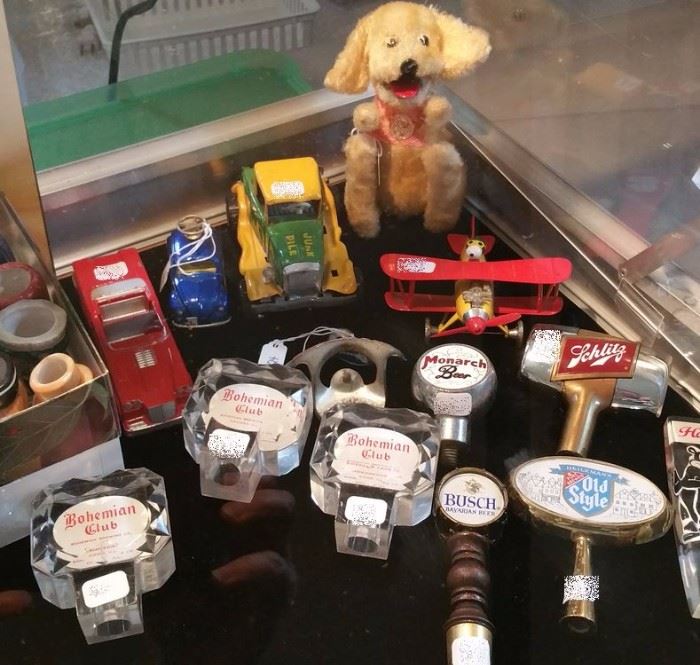 Vintage lucite tap handles for Behomian Club & Hamms. Great Schlitz pull and old old Monarch beer pull. Snoopy and the Red Baron plane, Topper Junk Pile car, Corgi Motor School Volkswagen, wind-up begging dog.