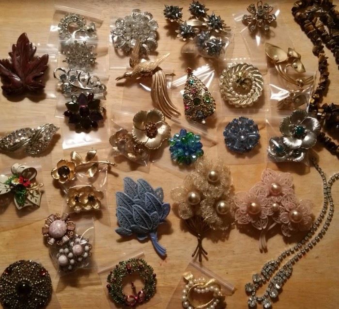 Costume jewelry includes brooches by Eisenberg and Trifari, plus some unsigned treasures and awesome plastic pieces.