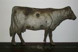 Cow weather vane with bullet holes