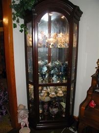 One of two matching curios with glass