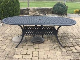 LARGE METAL TABLE WITH CHAIRS AND UMBRELLA