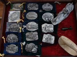 Collection of Iditarod Belt Buckles. Sculpture of Eskimo made of Mount St. Helens Ash