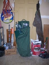 the big green bag has a picnic table and chairs in it, waders and more