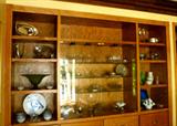 built in cabinets in the main room are filled with Murano glass, Fostoria crystal and beautiful collectibles
