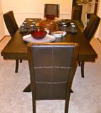 New Contemporary Dining table with leaf and 4 leather chairs.