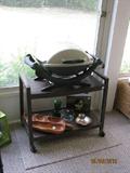 Weber gas grill, cart and home decor.