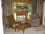Vintage leather chair and ottoman, mid-century adjustable book case hosting several authentic German steins and Berkline recliner.