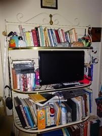 cook books and metal shelf unit flat screen tv