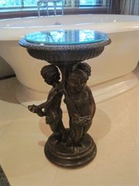 Bronze pedestal table with three central Putti.