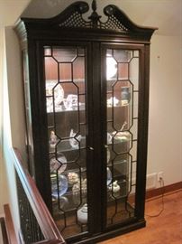 Curio cabinet with pierced swan pediment.