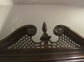 Curio cabinet with pierced swan pediment.