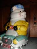 Piggy cookie jar driving his car.