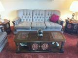 Two Matching Sofas, Side Tables and Coffee Table.  Lots of decorator pillows.  Two matching Brass Lamps (Touch).