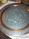 This is a great piece.  Looks like copper and silverplate.  Shape of a plate and hangs on the wall.