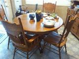 Round Oak Table in good condition with 1 large leaf and 6 Chairs.