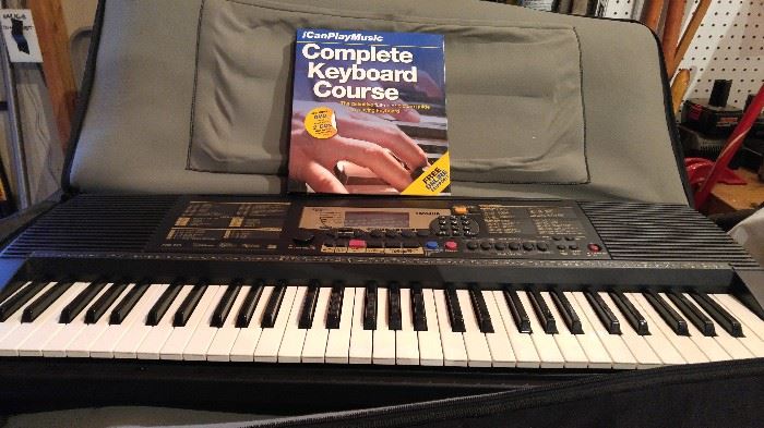 Yamaha keyboard, case, stand and beginners music book.