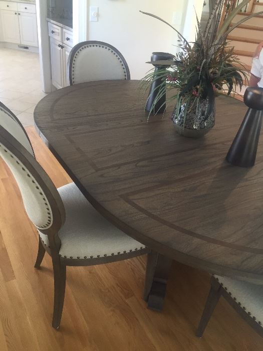 Oval dining table in a gray finish with 4 chairs by Bassett
