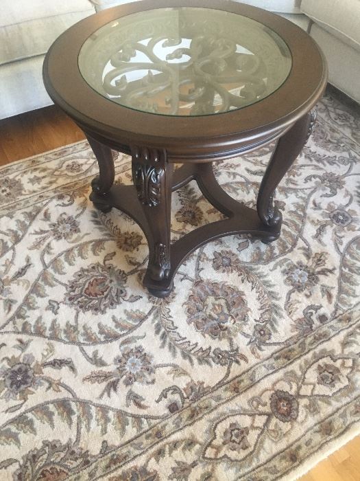 There are a pair of end tables and matching coffee table similar to this one .
