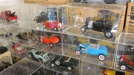 A FEW OF THE DIE-CAST METAL CAR MODELS IN CUSTOM LUCITE DISPLAY BOXES