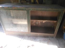 Heavy metal counter possibly  from a gas station, FRONT VIEW,  all here except 1 glass   back side has shelves and storage
