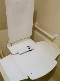 Gently used bath chair/lowers and lifts