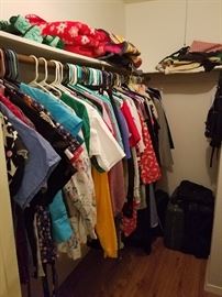 ladies scrubs size small in front of closet, pants are folded on table
