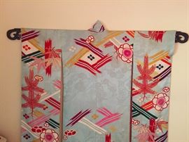 Vintage hand-painted silk kimono on hand carved Asian wood hanging rod.