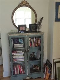 Antique mirror, cottage-style/shabby chic glass door cabinet.  Books, decor, art.