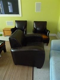 Oversized leather chair and two matching distressed leather club chairs