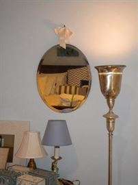 Beveled edged oval hanging mirror with bow and tulip floor lamp