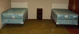 Matching twin beds with vintage headboards.  Box springs and mattress look new.