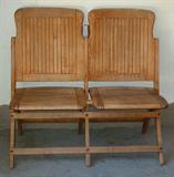 Antique church pew with hymnal slots in back.