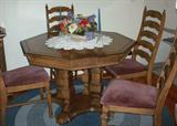Beautiful Oak Dining table with 3 leaves.  Included are 6 chairs - two are captains.  The captains chairs are currently in the master bedroom, if you are interested.