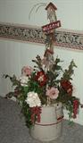 This photo shows one of the antique crocks with some of the floral offerings and one of the yard pics.