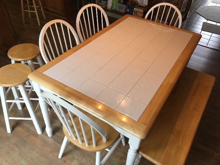 Tile top wooden ding in table. Includes 4 chairs, bench & 2 stools. Comfortably seats 6.